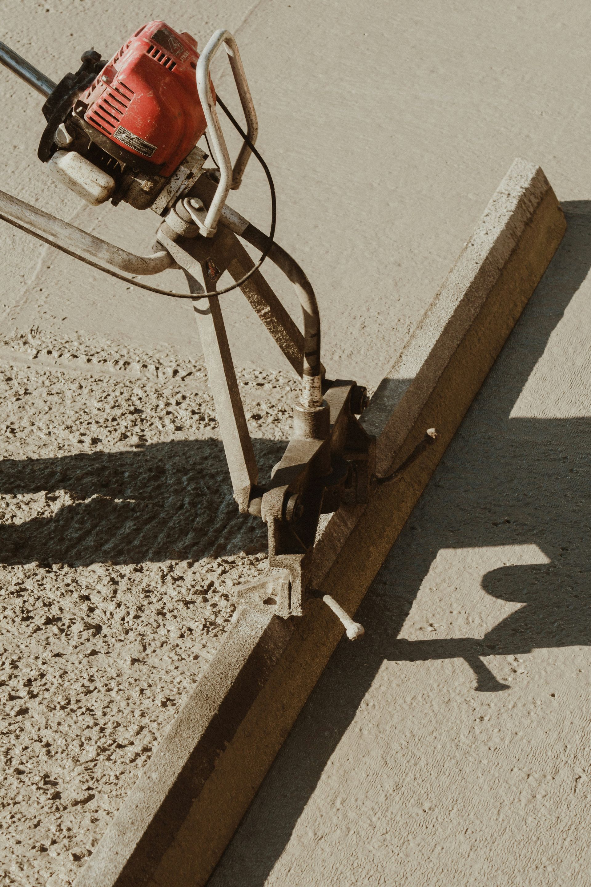 a red and black machine on a sidewalk